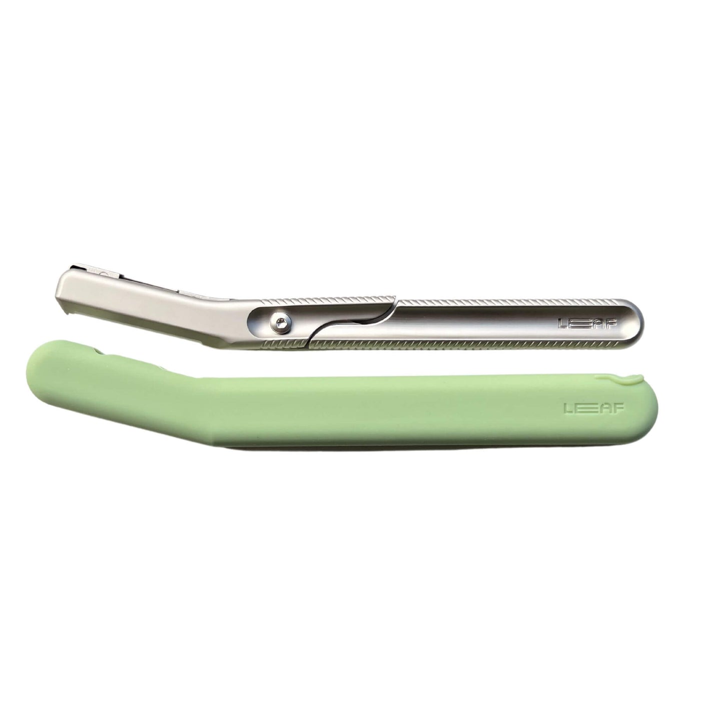the leaf dermaplaner cover in green silicone next to the leaf dermaplaner in silver - they are lying side by side