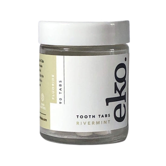 small glass jar with white lid containing tooth tabs from ekotoothtabs -  rivermint flavour with fluoride 