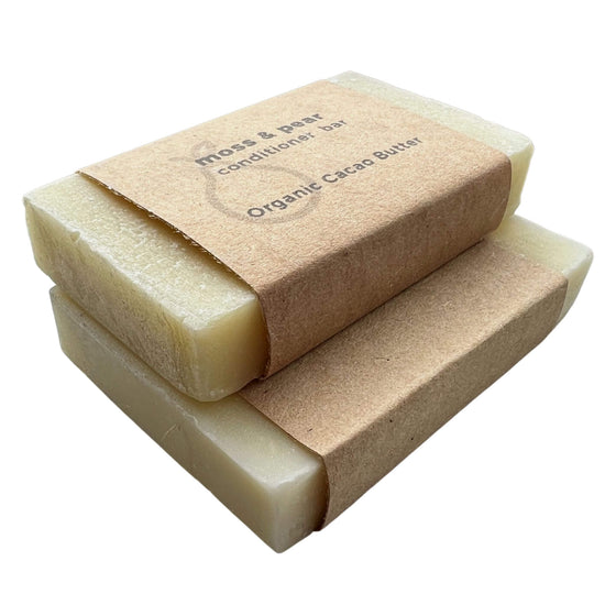 moss & pear organic cacao butter conditioner bar in 2 sizes with brown paper wrapping label